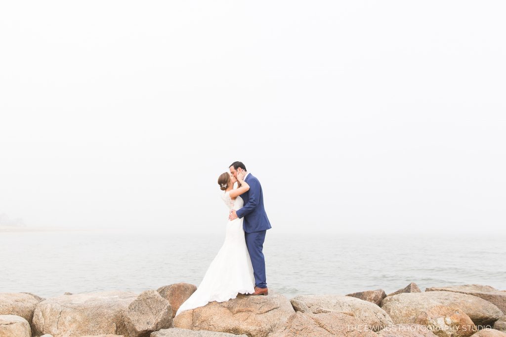 This is a portrait of a bride and groom at Popponesset Beach in Falmouth by the best Cape Cod wedding photographers, The Ewings.