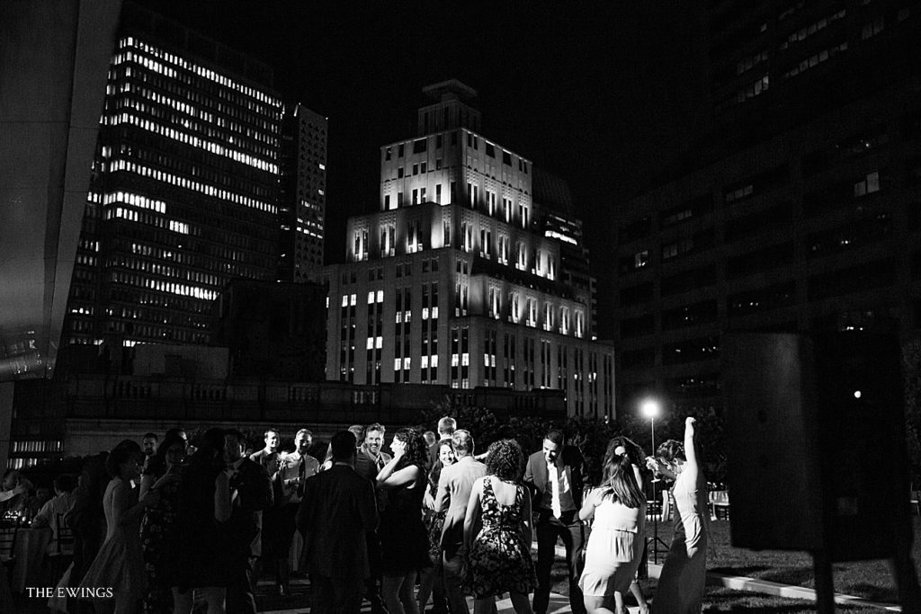 Here's an evening look at a wedding at 9OFS as guests dance into the night with the city skyline close behind.
