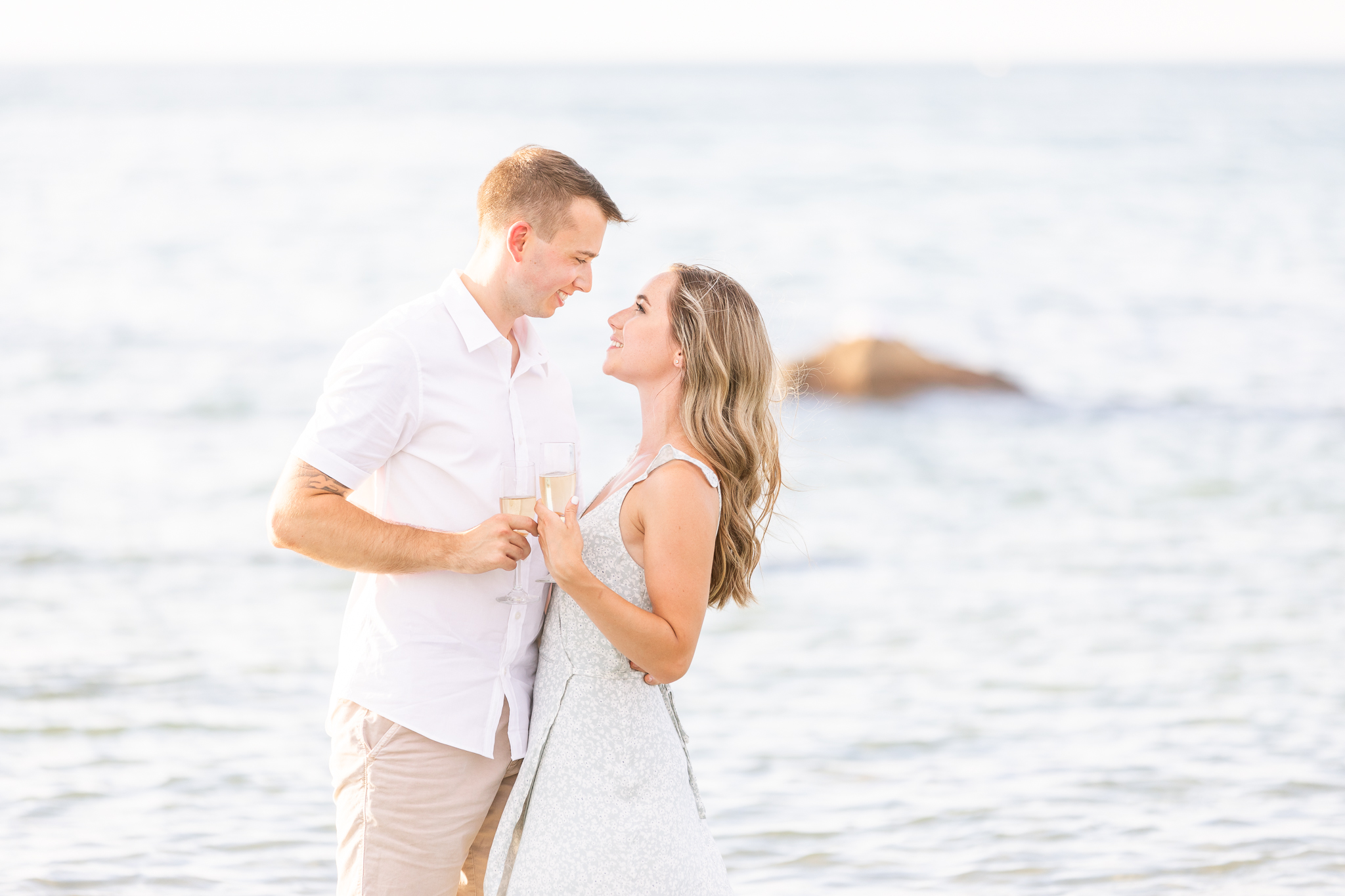 A Gloucester MA beach engagement session that is light and airy in the ocean.
