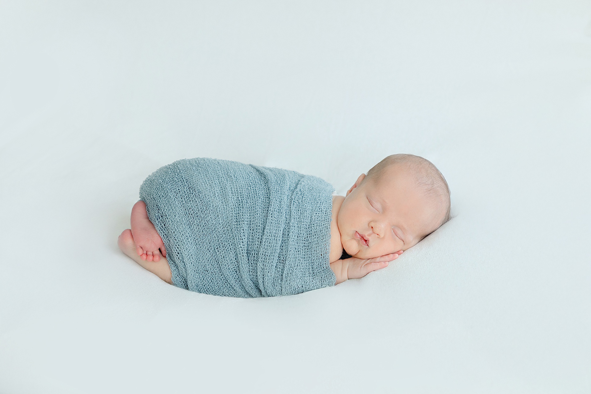 An in-home newborn session with Winchester MA Newborn Photographer, Erica Ewing, one of the best newborn photographers in the greater boston area. This is a gently posed newborn portrait.