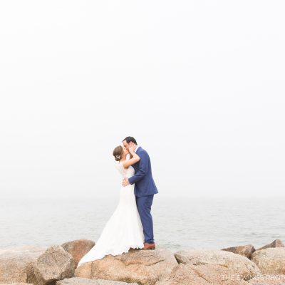This is a portrait of a bride and groom at Popponesset Beach in Falmouth by the best Cape Cod wedding photographers, The Ewings.